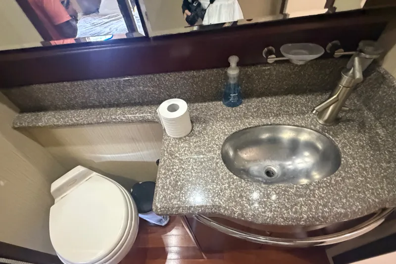 Slide: The Image of Luxurious bathroom in 2006 Sea Ray 550 Sedan Bridge yacht with granite countertop and modern fixtures. - 84