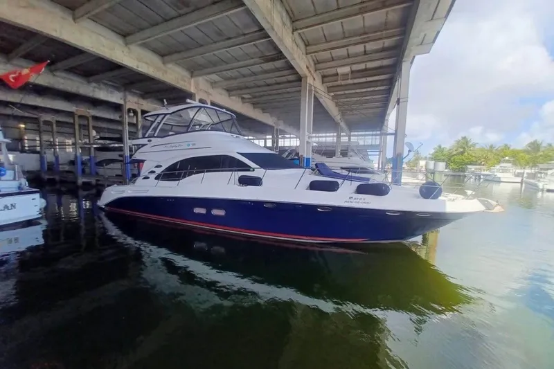 The Image of 2006 Searay Sedan Bridge yacht docked under a covered marina. - 3