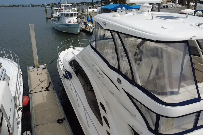 Slide: The Image of 2006 Sea Ray 550 Sedan Bridge yacht docked at marina, side view. - 25