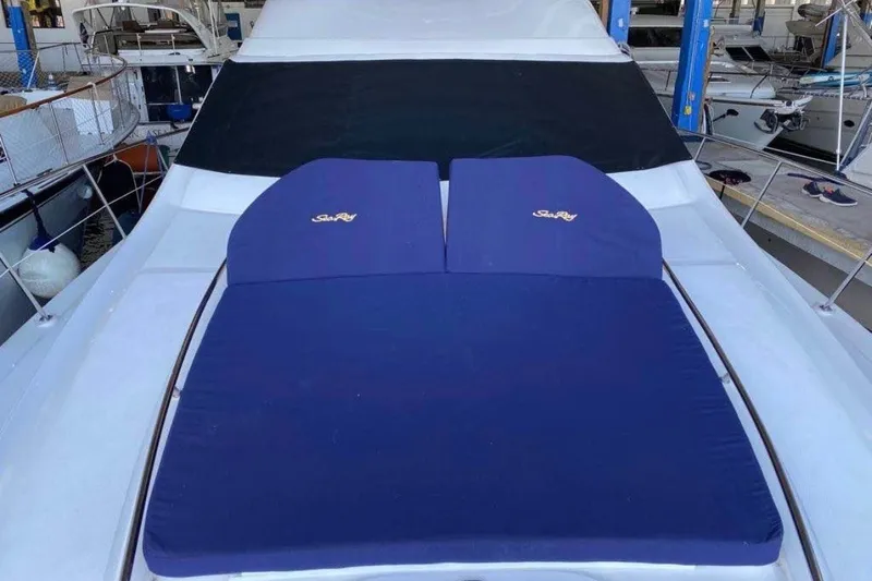 Slide: The Image of 2006 Searay Sedan Bridge yacht with blue sun pads on deck. - 5