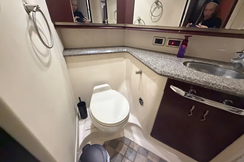 Slide: The Image of Bathroom interior of 2006 Sea Ray 550 Sedan Bridge yacht, featuring toilet and sink. - 104