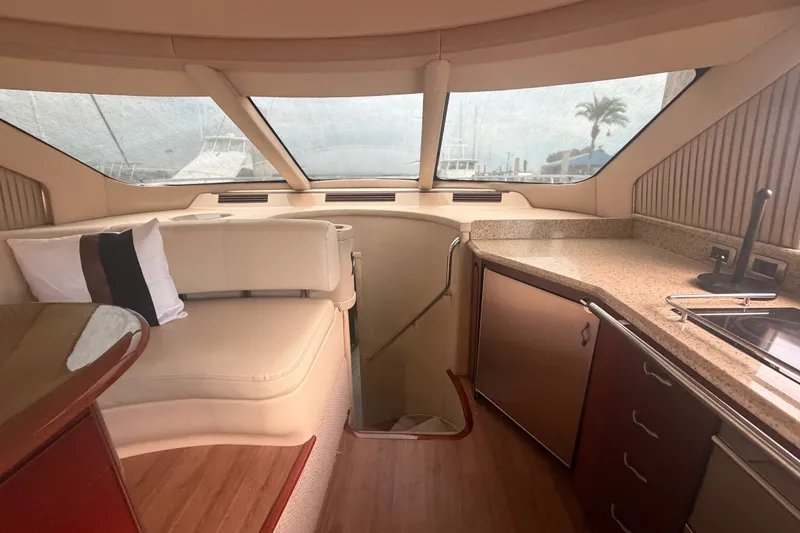 Slide: The Image of Luxurious interior of a 2006 Sea Ray 550 Sedan Bridge yacht with elegant seating and kitchenette. - 67