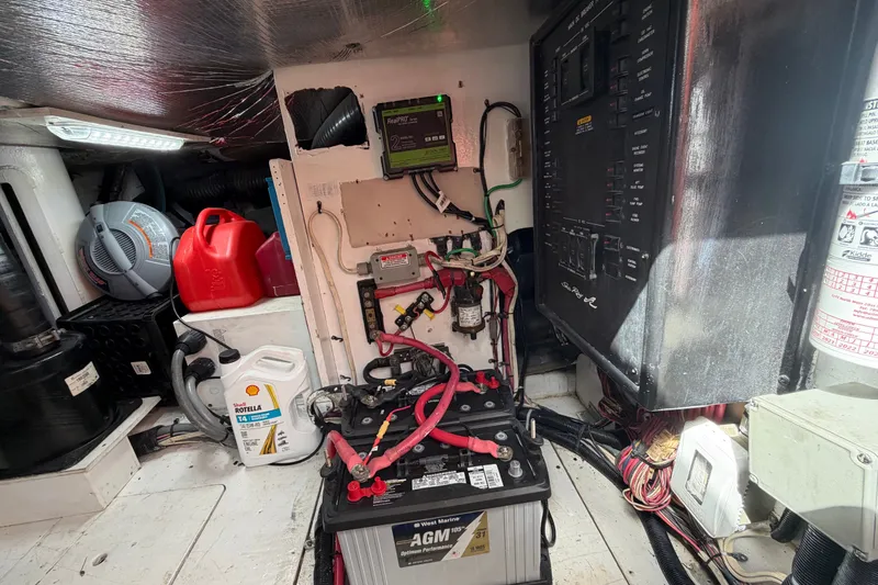 Slide: The Image of Electrical panel and battery setup in a 2006 Sea Ray 550 Sedan Bridge yacht. - 147
