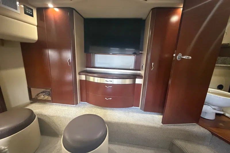 Slide: The Image of Luxurious interior of 2006 Sea Ray 550 Sedan Bridge with wood cabinetry and modern amenities. - 76