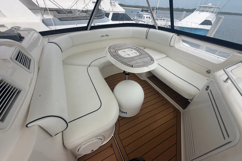 Slide: The Image of Luxurious seating area on 2006 Sea Ray 550 Sedan Bridge yacht with elegant wood table. - 56