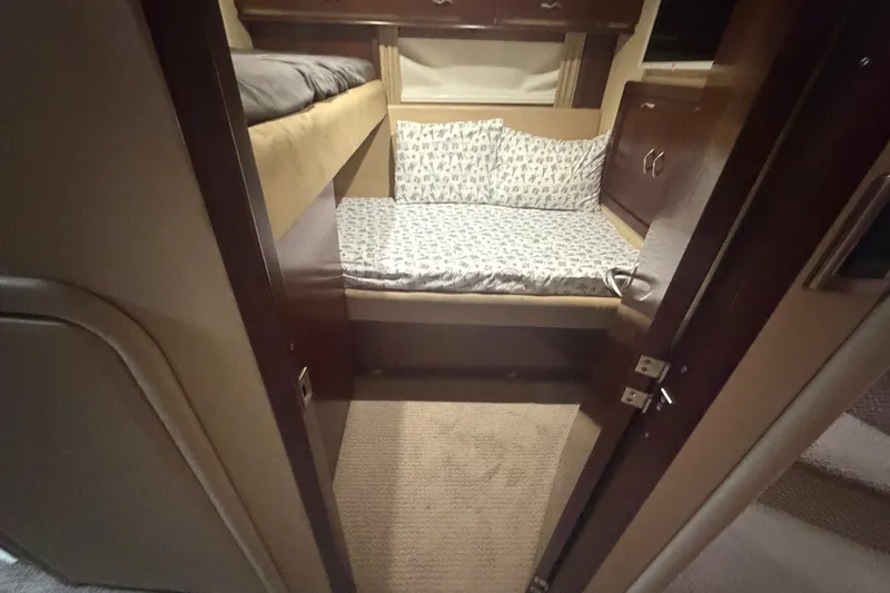Slide: The Image of Interior cabin of 2006 Sea Ray 550 Sedan Bridge with bunk beds and wooden cabinetry. - 96