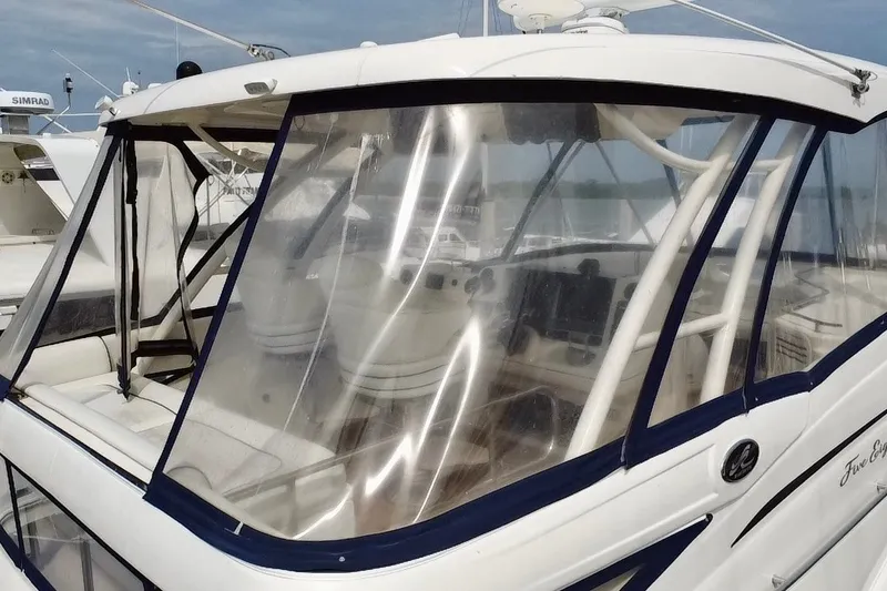 Slide: The Image of 2006 Sea Ray 550 Sedan Bridge yacht with clear enclosure and visible cockpit controls. - 19