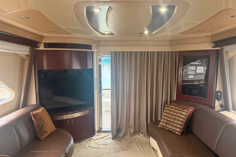 Slide: The Image of Interior of 2006 Sea Ray 550 Sedan Bridge yacht with luxurious seating and entertainment area. - 62