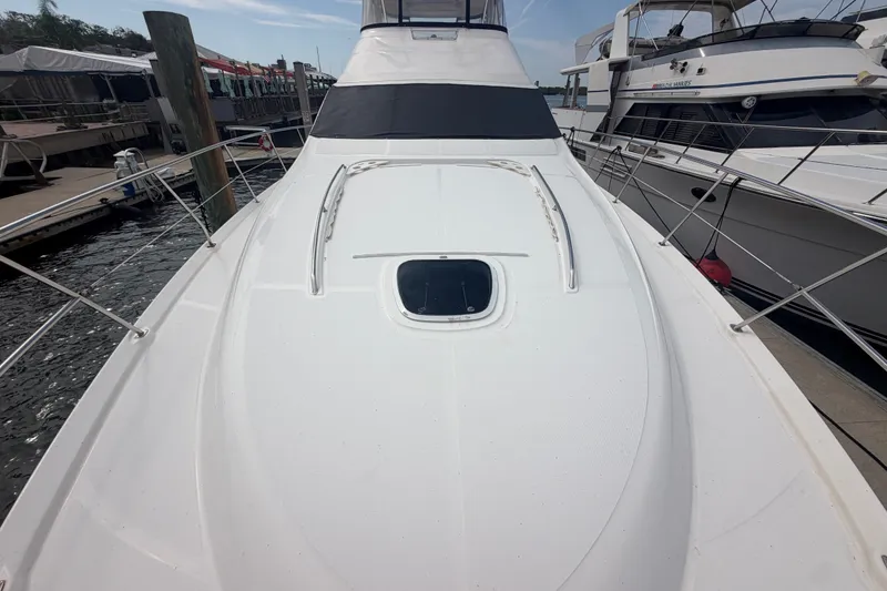 Slide: The Image of 2006 Sea Ray 550 Sedan Bridge yacht docked at marina, showcasing sleek deck design. - 34