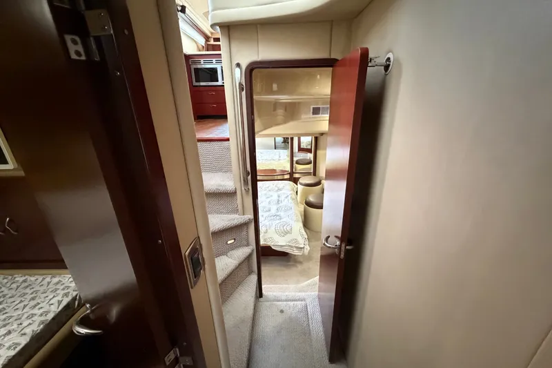 Slide: The Image of Interior view of 2006 Sea Ray 550 Sedan Bridge yacht, featuring stairs and cozy cabin. - 124