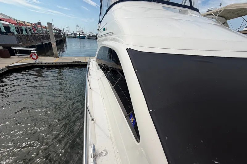Slide: The Image of 2006 Sea Ray 550 Sedan Bridge yacht docked at a marina, side view. - 40