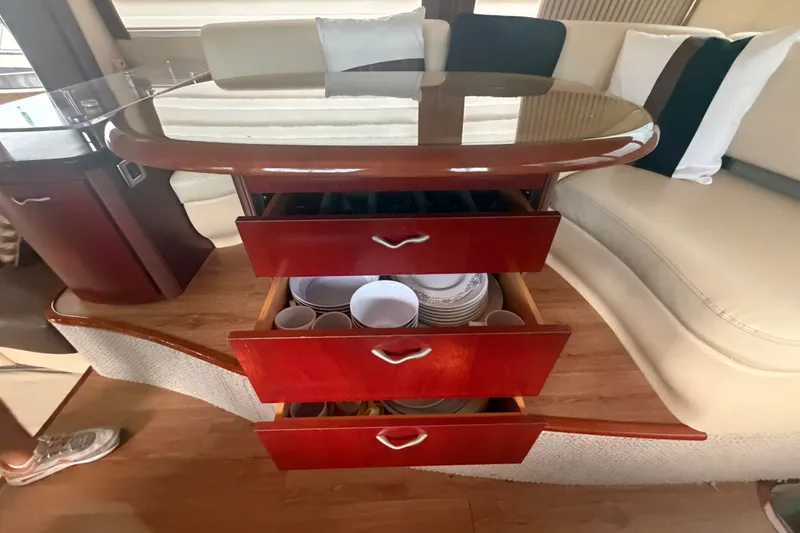 Slide: The Image of Luxury yacht interior with open drawers displaying dishes, Sea Ray 550 Sedan Bridge, 2006 model. - 70