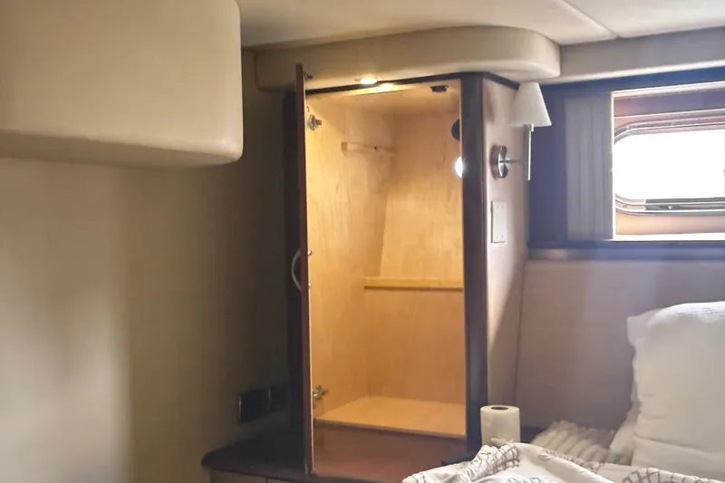Slide: The Image of Interior cabin of 2006 Sea Ray 550 Sedan Bridge with open closet and window. - 87