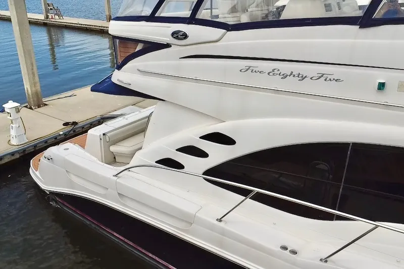 Slide: The Image of 2006 Sea Ray 550 Sedan Bridge yacht docked at marina, side view. - 2