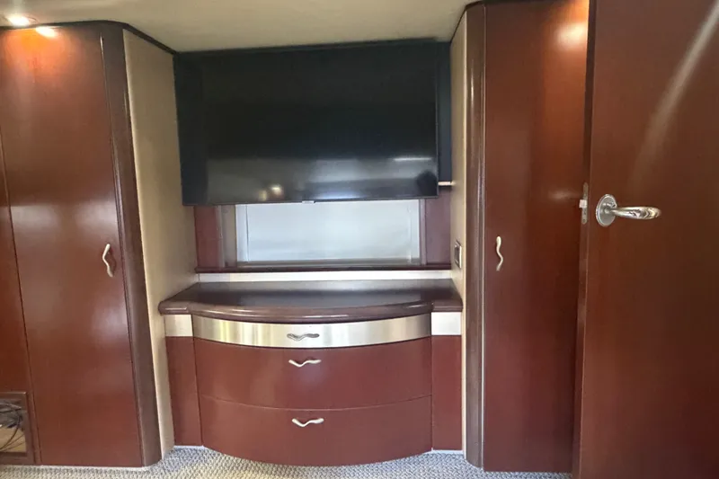 Slide: The Image of Luxurious interior of 2006 Sea Ray 550 Sedan Bridge with wood cabinetry and TV. - 77