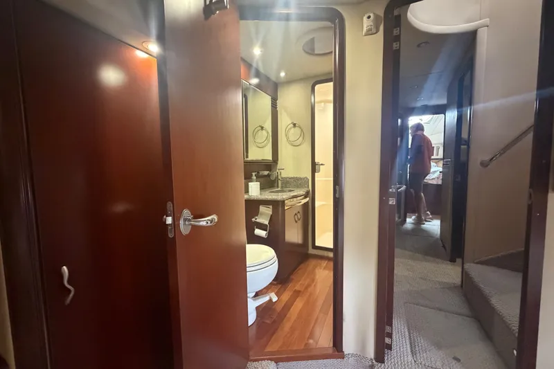 Slide: The Image of Interior of 2006 Sea Ray 550 Sedan Bridge yacht, featuring a bathroom and hallway. - 82