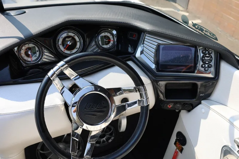 Slide: The Image of Steering wheel and dashboard of 2013 Tigé Z3 boat with gauges and controls. - 40