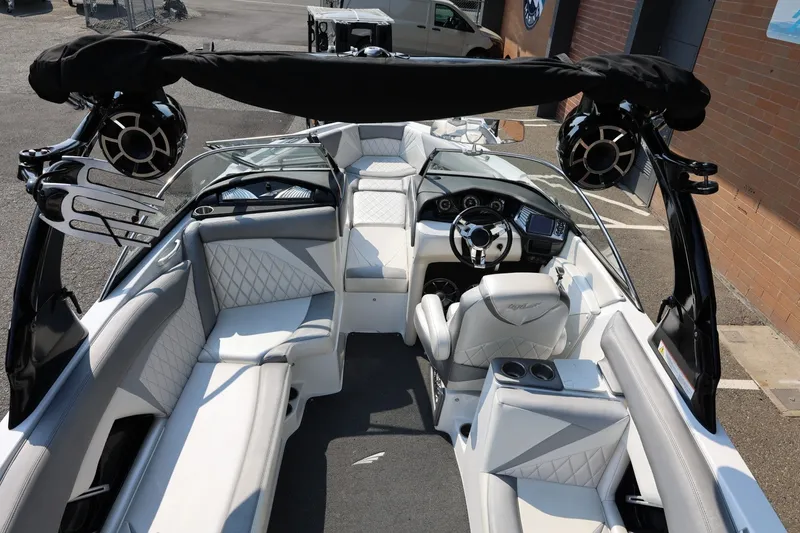 Slide: The Image of 2013 Tigé Z3 boat interior with white seating, steering wheel, and audio speakers. - 22
