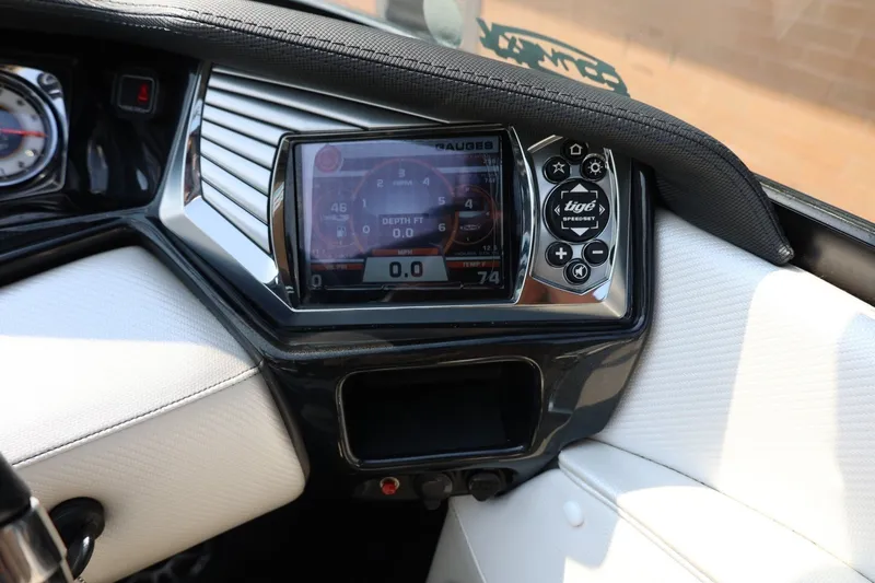 Slide: The Image of Dashboard of a 2013 Tigé Z3 boat with digital display and controls. - 42