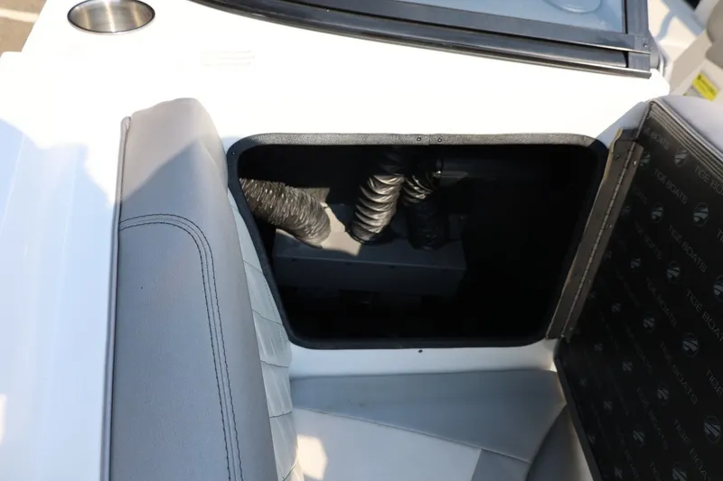 Slide: The Image of 2013 Tigé Z3 boat interior storage compartment with gray seating and cup holder. - 48