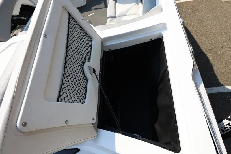 Slide: The Image of 2013 Tigé Z3 boat storage compartment with open hatch and netting. - 17