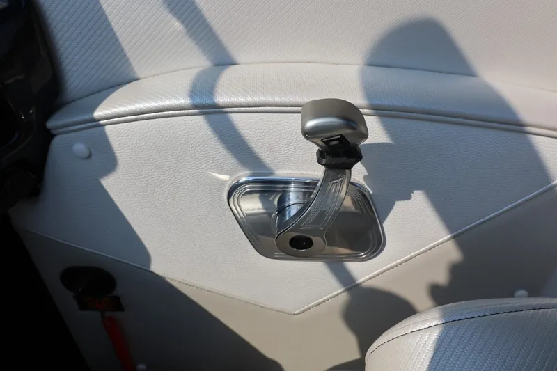 Slide: The Image of Interior detail of 2013 Tigé Z3 boat, featuring a sleek control lever on white upholstery. - 44