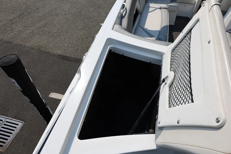 Slide: The Image of Open storage compartment on a 2013 Tigé Z3 boat, featuring white interior and seating. - 18