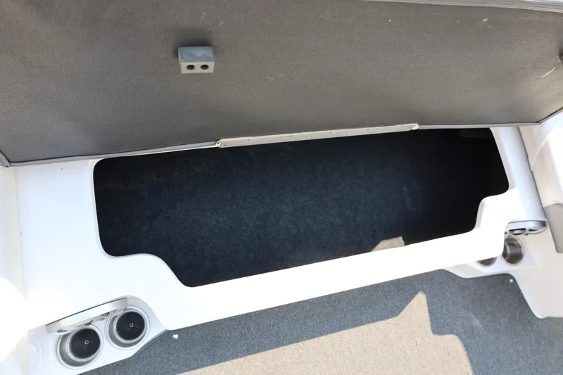 Slide: The Image of Storage compartment in a 2013 Tigé Z3 boat, featuring cup holders and carpeted interior. - 34