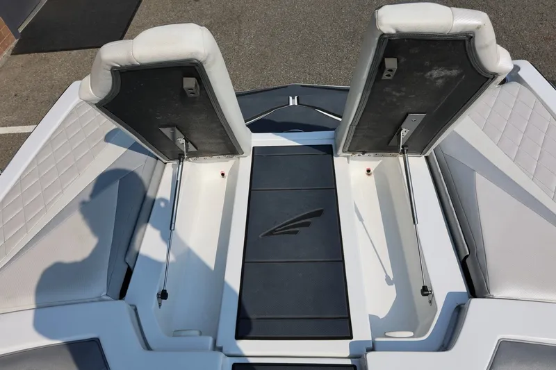 Slide: The Image of 2013 Tigé Z3 boat interior with open storage compartments and cushioned seating. - 23