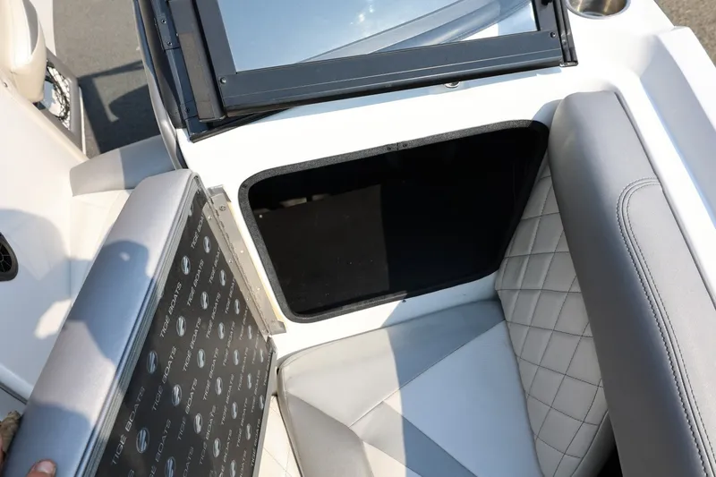 Slide: The Image of 2013 Tigé Z3 boat interior with open storage compartment and quilted seating. - 49