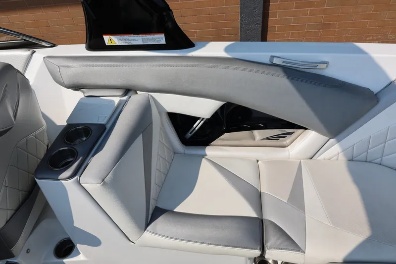 Slide: The Image of Interior seating of a 2013 Tigé Z3 boat with cup holders and stylish upholstery. - 31
