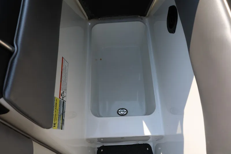 Slide: The Image of Interior storage compartment of a 2013 Tigé Z3 boat, featuring a drain plug. - 46