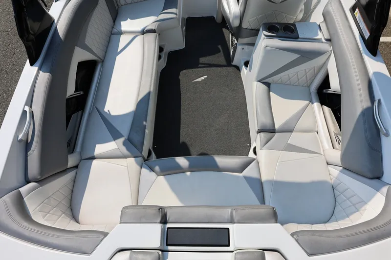 Slide: The Image of 2013 Tigé Z3 boat interior with gray and white seating, cup holders, and carpeted floor. - 20