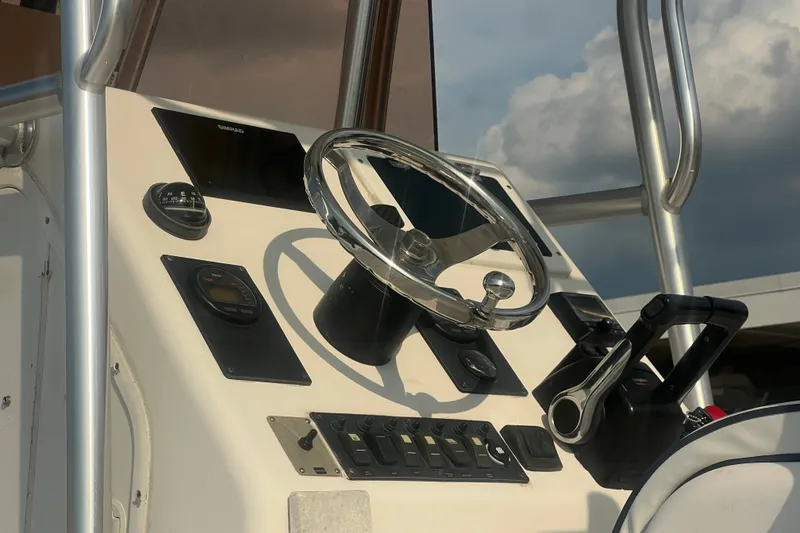 Slide: The Image of 2007 Clearwater 2300 Center Console boat dashboard with steering wheel and controls. - 9