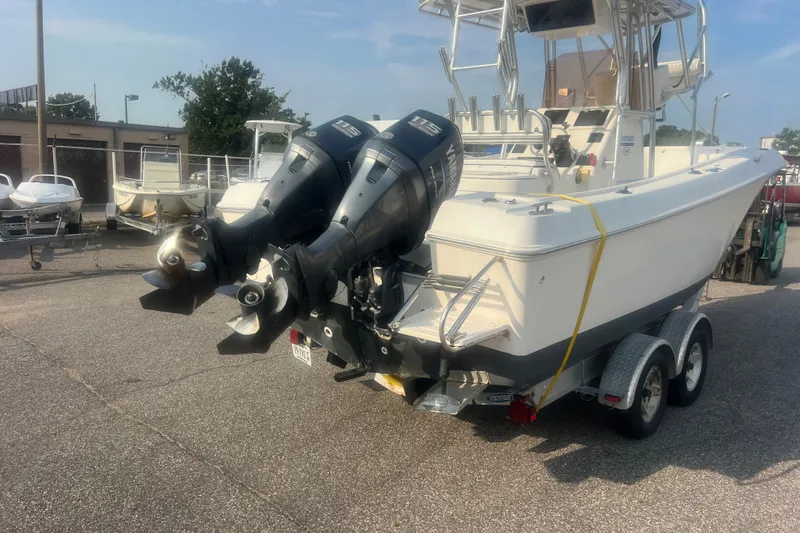 Slide: The Image of 2007 Clearwater 2300 Center Console boat with dual outboard motors on a trailer. - 4
