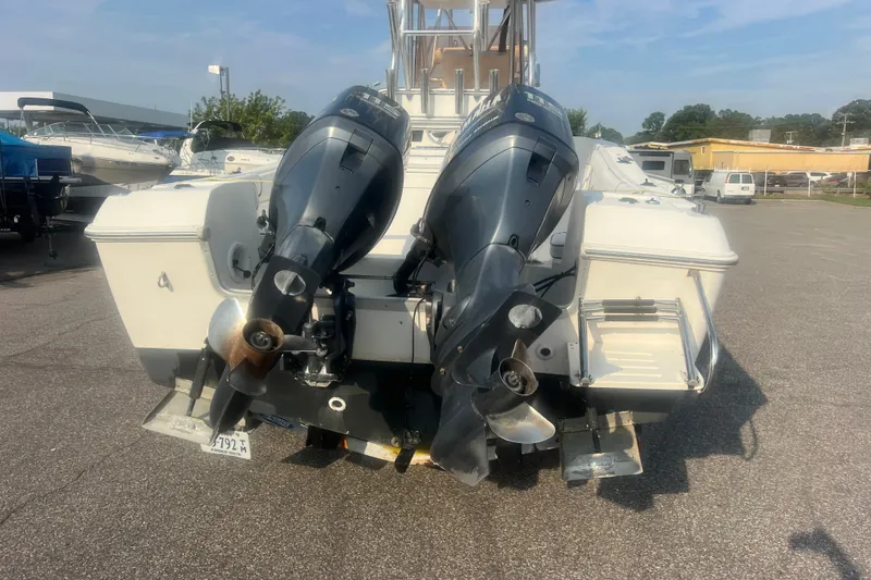 Slide: The Image of 2007 Clearwater 2300 Center Console boat with dual outboard motors in a marina. - 5