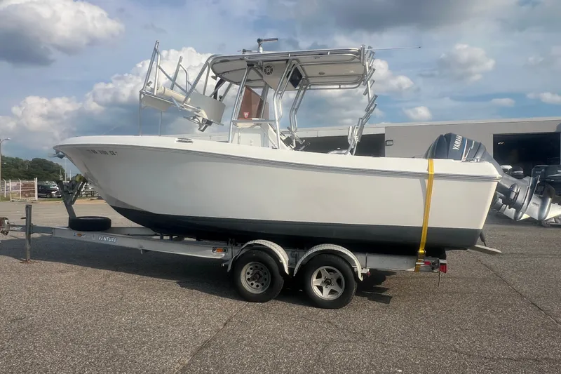 Slide: The Image of 2007 Clearwater 2300 Center Console boat on trailer under cloudy sky. - 8