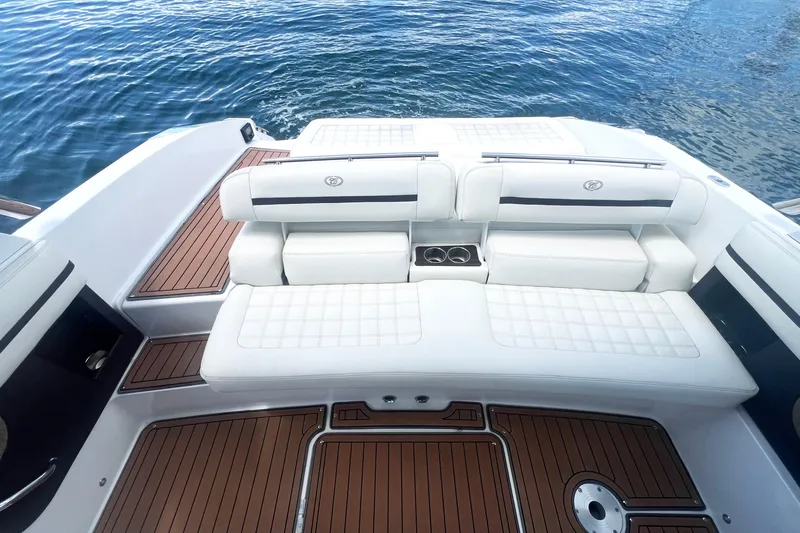 Slide: The Image of 2017 Cobalt R30 boat with white seating and teak flooring on water. - 21