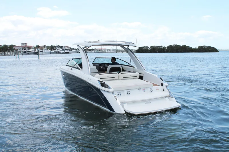 Slide: The Image of 2017 Cobalt R30 boat cruising on a calm waterway near a marina. - 8