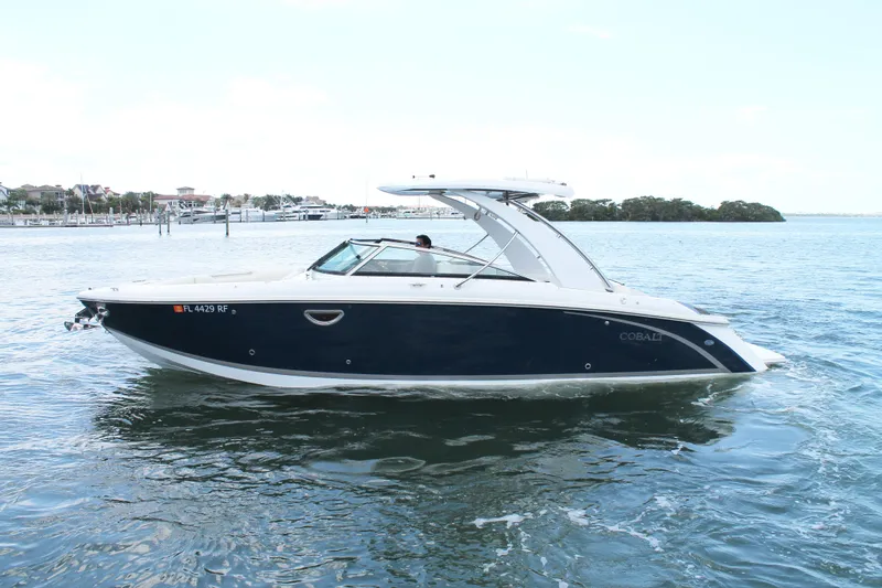 Slide: The Image of 2017 Cobalt R30 boat cruising on a calm waterway, showcasing sleek design and luxury. - 5