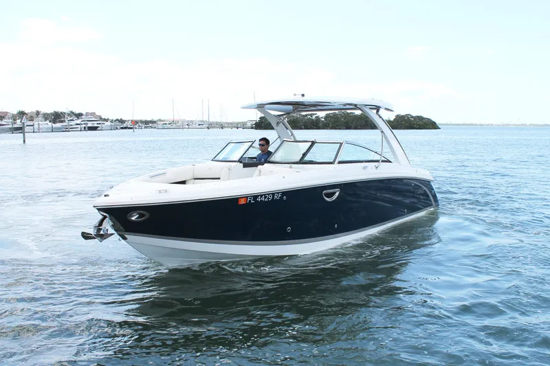 Slide: The Image of 2017 Cobalt R30 boat cruising on calm waters with a clear sky backdrop. - 1