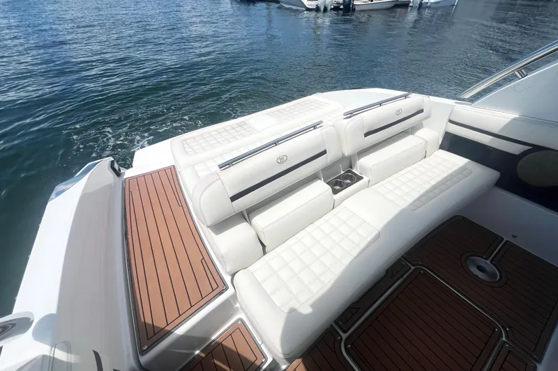 Slide: The Image of 2017 Cobalt R30 boat with white seating and wooden deck on water. - 20