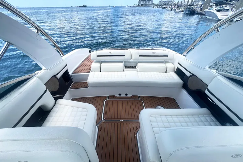 Slide: The Image of Luxurious 2017 Cobalt R30 boat interior with white seating and wooden flooring on a sunny day. - 23