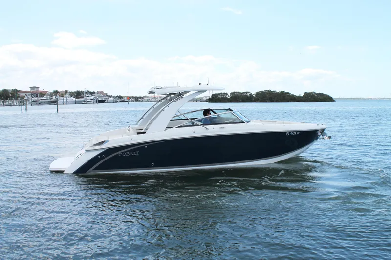 Slide: The Image of 2017 Cobalt R30 boat cruising on a calm lake with scenic background. - 12