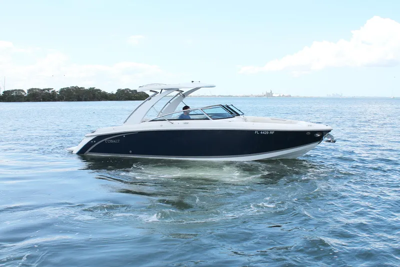Slide: The Image of 2017 Cobalt R30 boat cruising on open water under clear skies. - 13