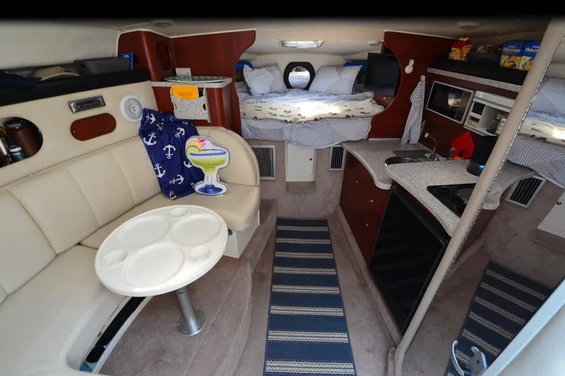 Slide: The Image of Interior of 2002 Rinker Fiesta Vee 310 boat with cozy seating and kitchenette. - 18