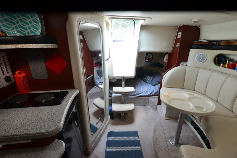 Slide: The Image of Interior of 2002 Rinker Fiesta Vee 310 boat with kitchen and seating area. - 22