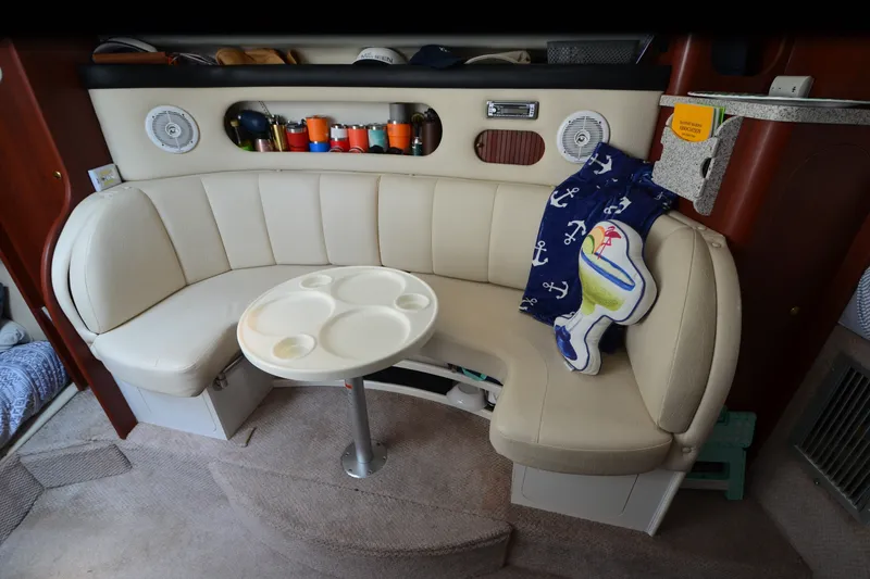 Slide: The Image of 2002 Rinker Fiesta Vee 310 interior with beige seating and round table. - 20