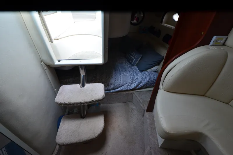 Slide: The Image of Interior cabin of 2002 Rinker Fiesta Vee 310 with steps and cozy bedding. - 21