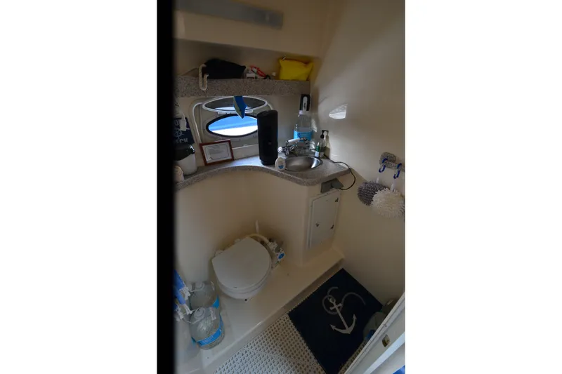 Slide: The Image of Bathroom interior of 2002 Rinker Fiesta Vee 310 boat with sink and toilet. - 24
